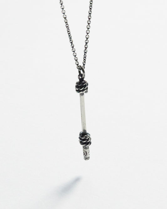 antique silver necklace with a unique pendant on a white background