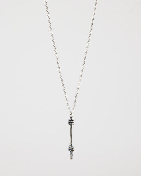 Silver necklace with a unique pendant on a light gray background