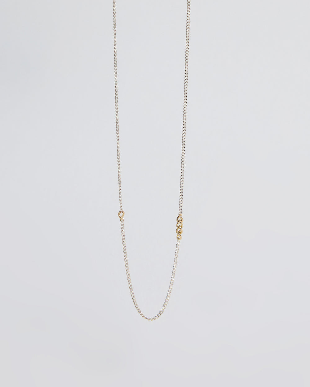 Minimalist sterling silver chain necklace featuring small gold link accents
