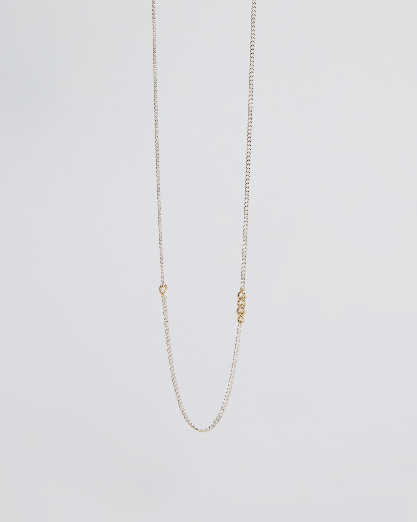 Minimalist sterling silver chain necklace featuring small gold link accents