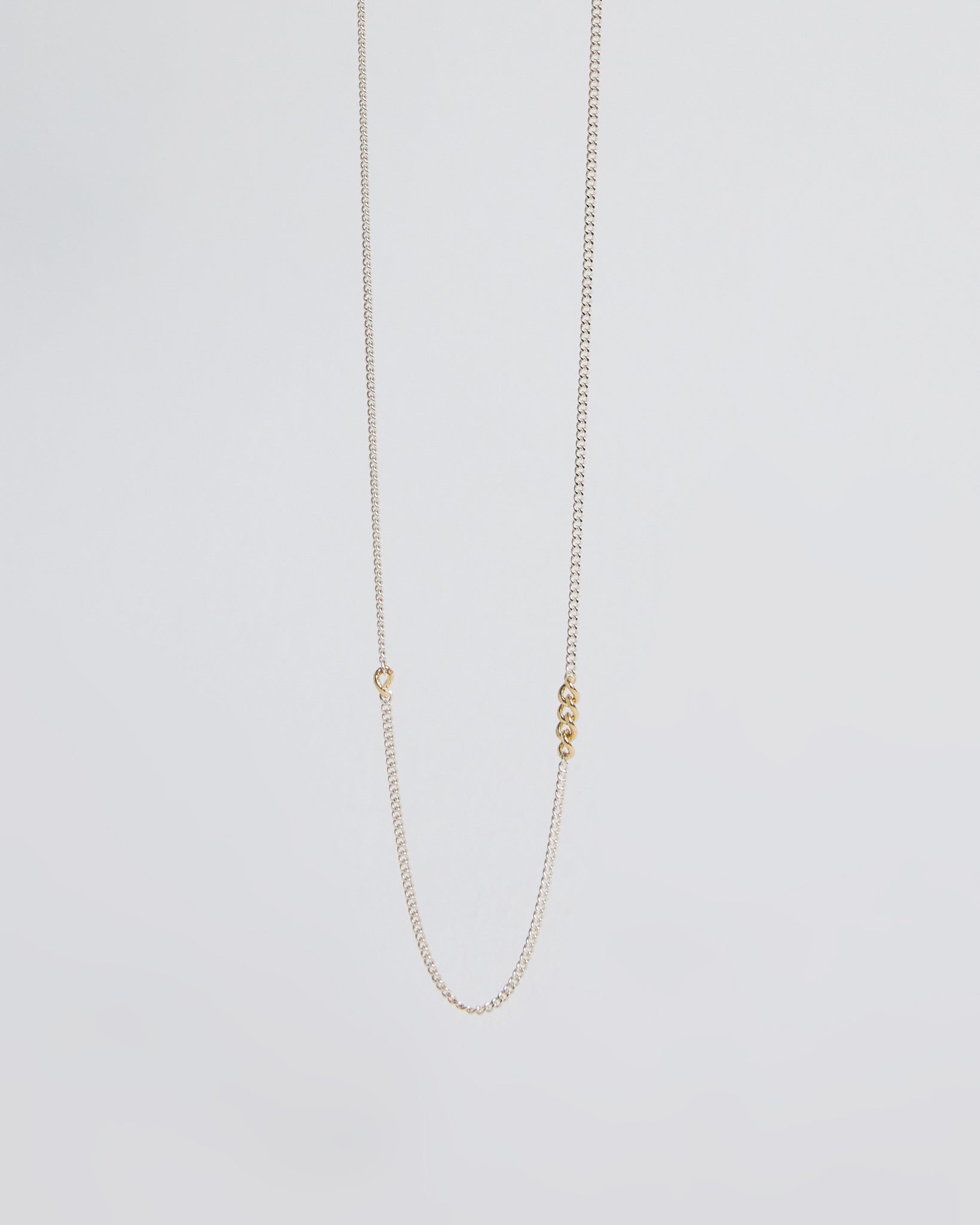 Minimalist sterling silver chain necklace featuring small gold link accents