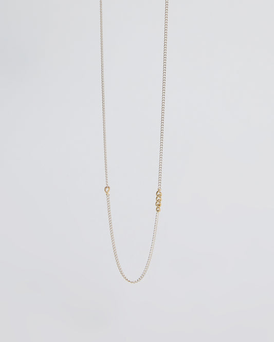 Minimalist sterling silver chain necklace featuring small gold link accents