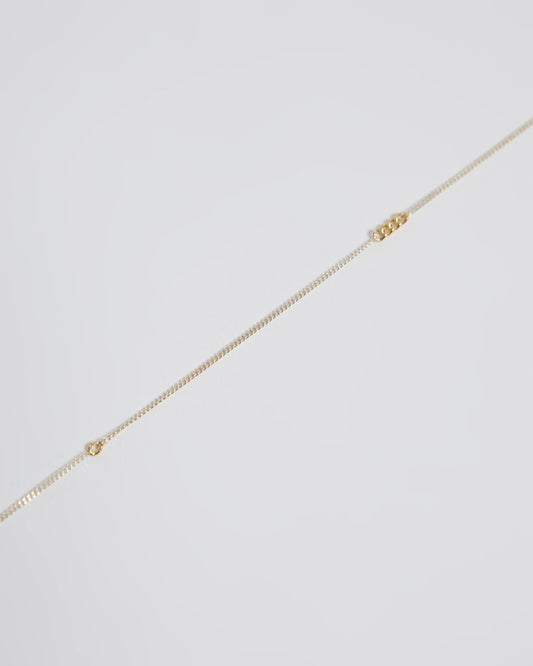 Close-up detail of sterling silver chain necklace with interconnected gold links