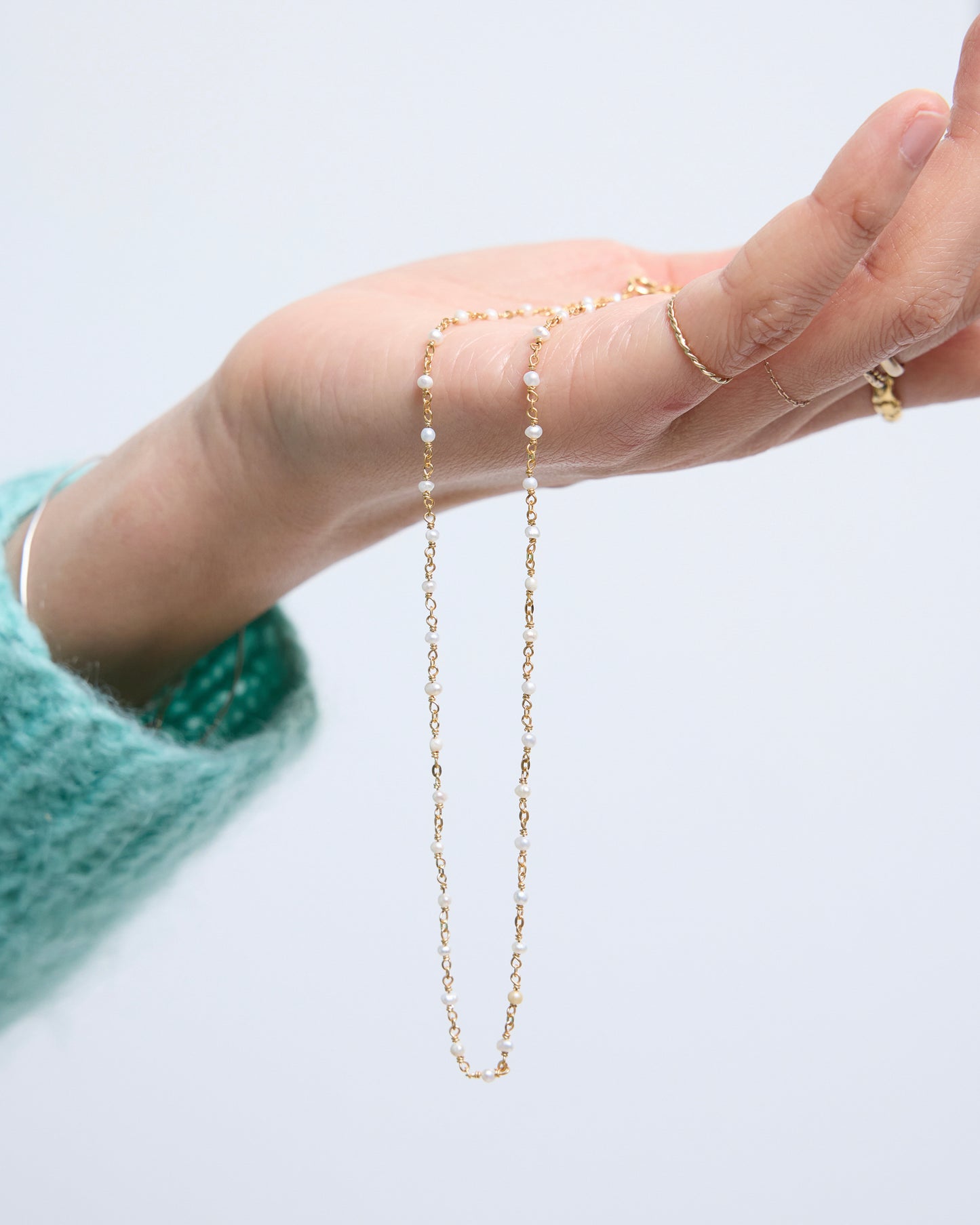 full length view of evenly spaced pearls on a fine chain