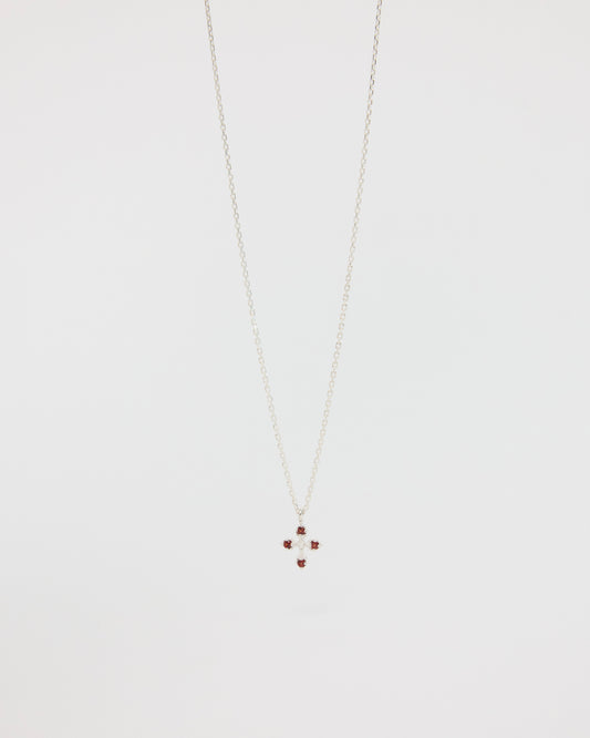 Necklace with a small cross pendant on a light gray background