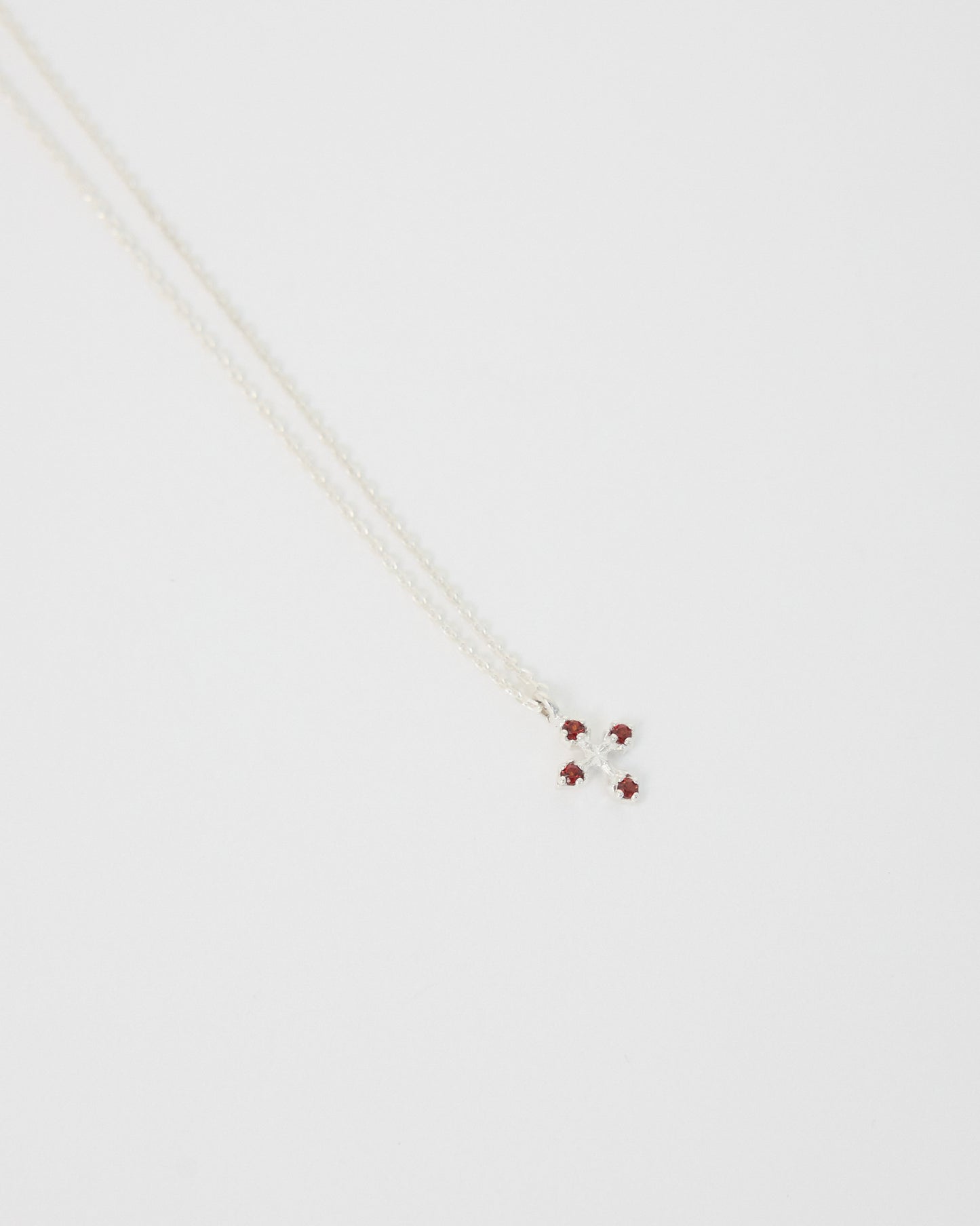 Necklace with small red beads on a white background