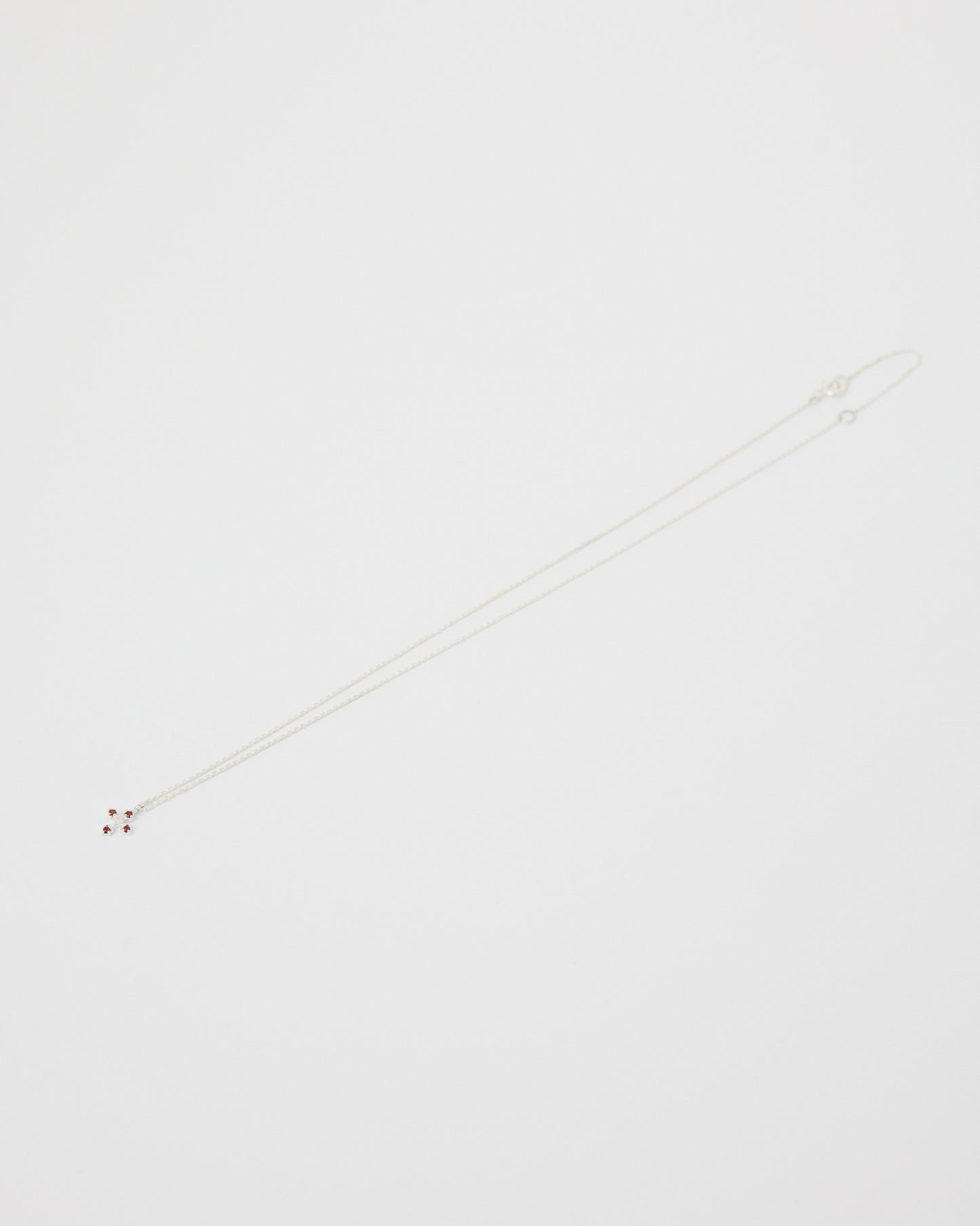 White necklace on a light gray background