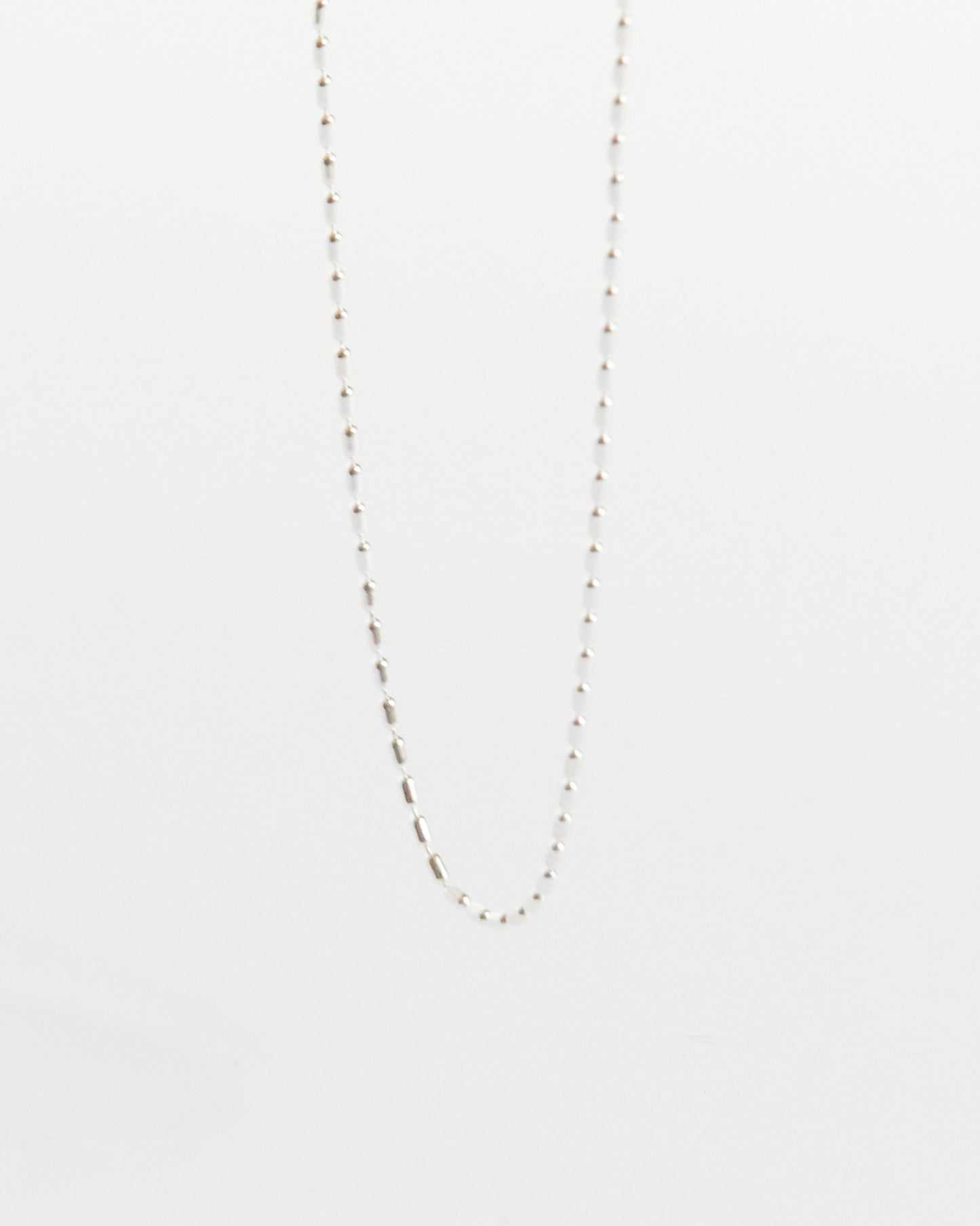 a soft silver line across the collarbone doing just enough (and never too much)