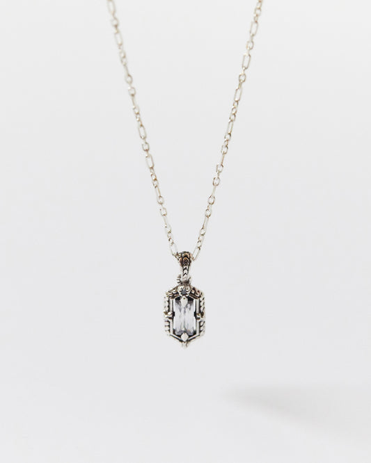 Silver necklace with a rectangular pendant on a white background