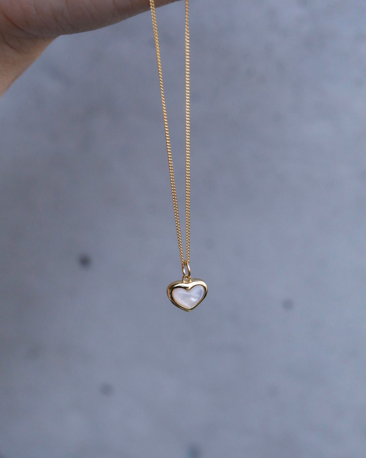 everyday gold heart necklace worn close to skin
