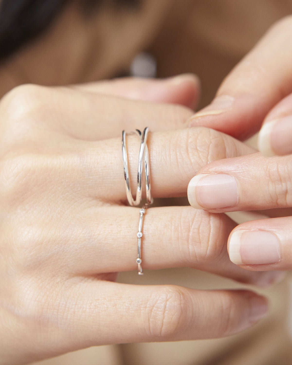 Silver open triple line ring worn on the middle finger with a thin ring below – HANNA543 R506 triple air lines