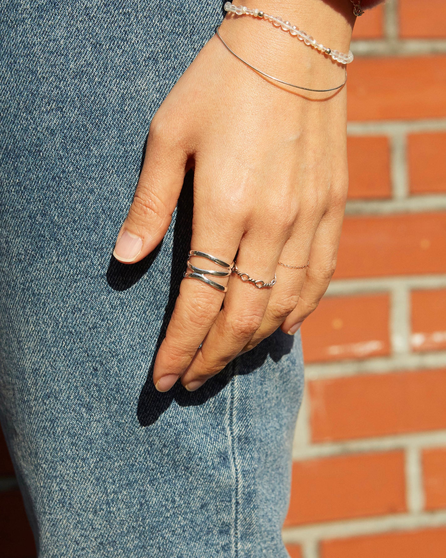conceptual silver ring with repeated loop elements, minimal art-inspired jewelry