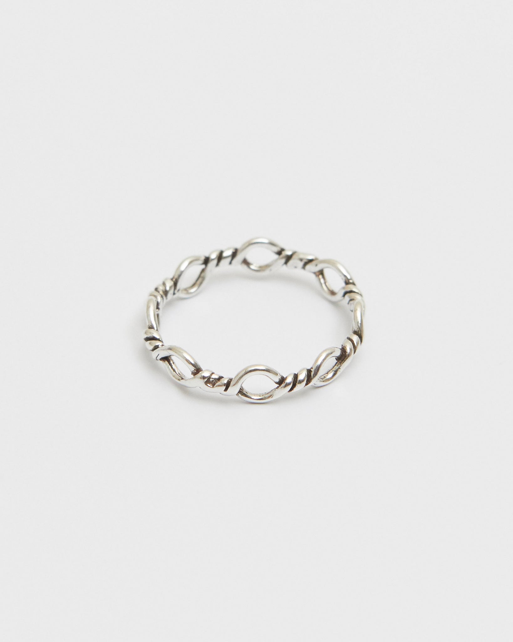 architectural silver ring composed of interlinked loop forms, geometric and minimal design