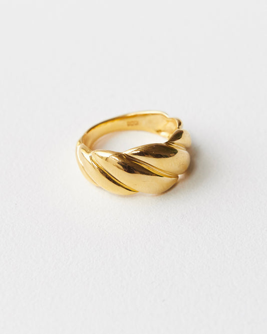 architectural twisted ring with sculpted volume and continuous curved form in polished metal