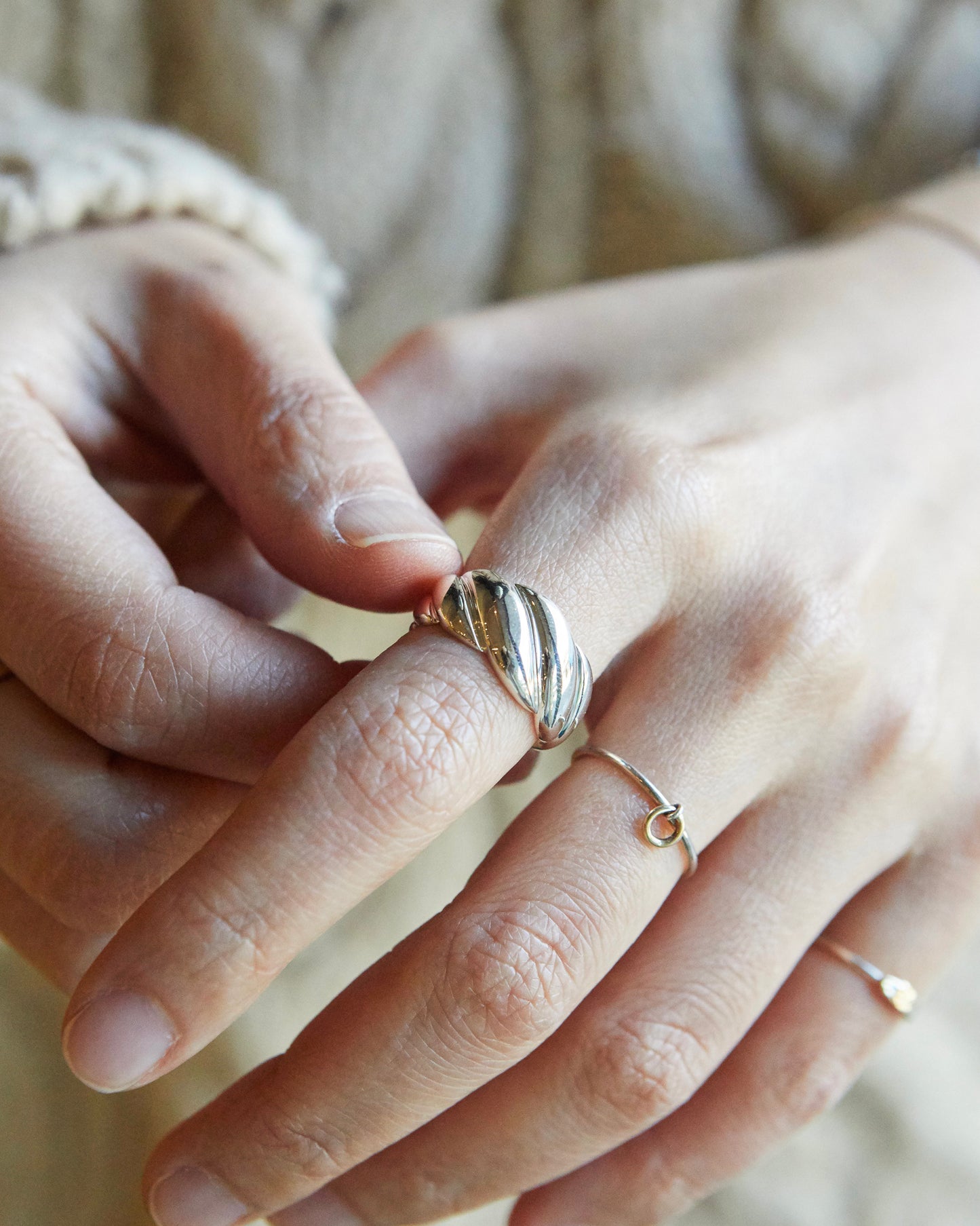 twisted metal ring with playful sculptural curve, modern minimalist jewelry