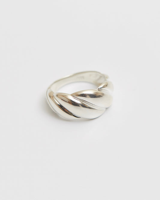 architectural twisted ring with sculpted volume and continuous curved form in polished metal