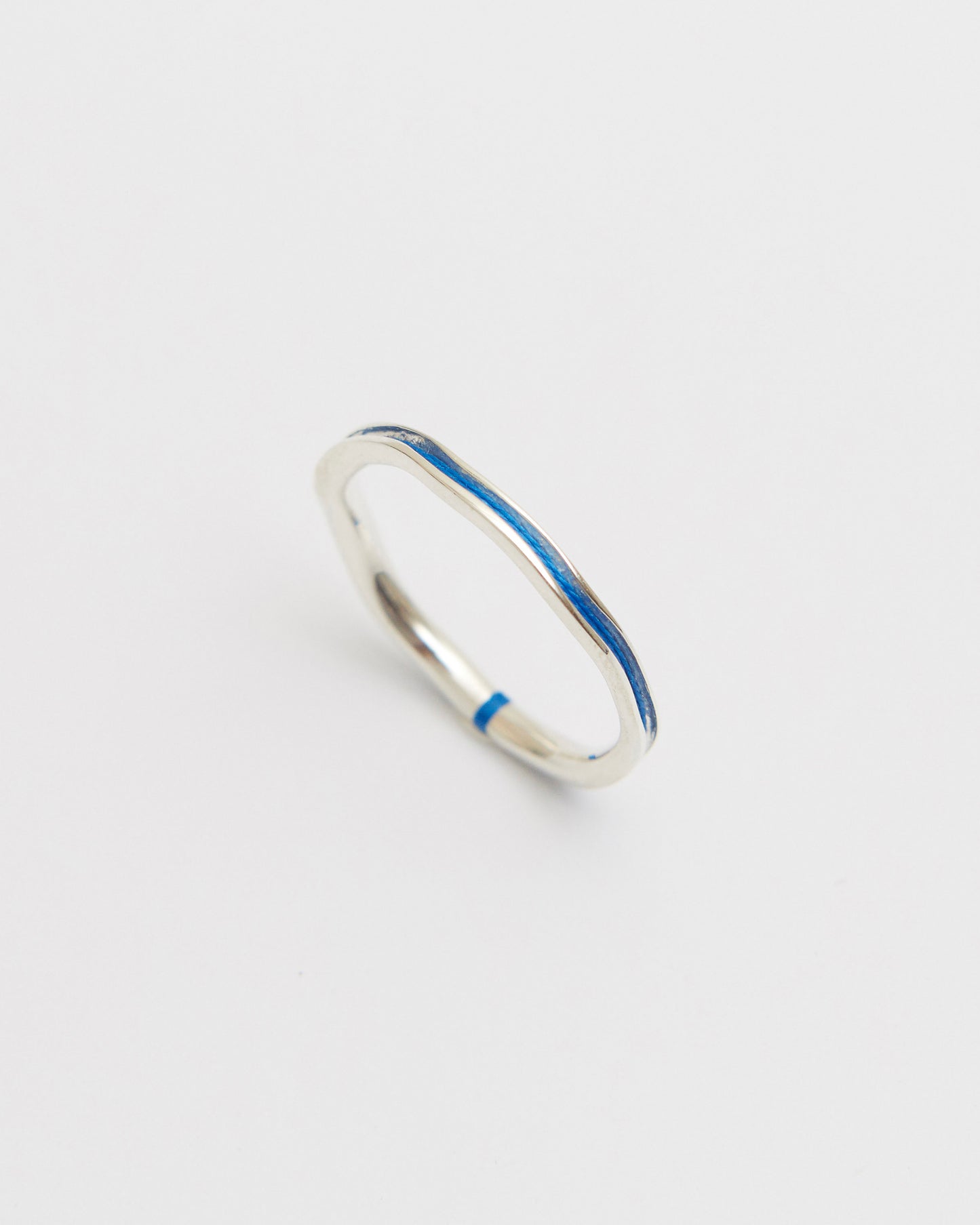 Silver ring with a cobalt blue on a light gray background