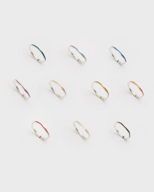 Set of silver rings with multicolored accents on a white background