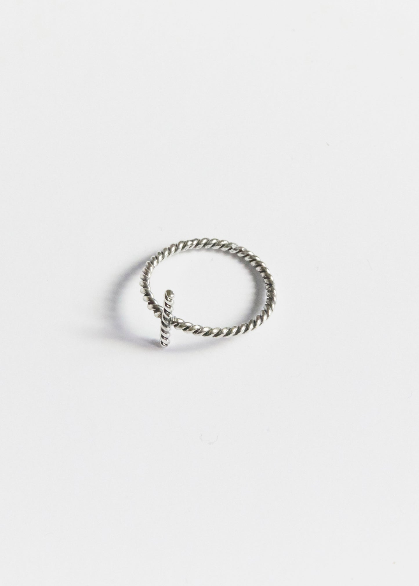 a tiny cross ring quietly doing all the emotional heavy lifting